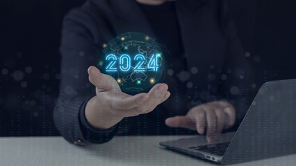 Businessman with world icon and year 2024 for start preparing Merry Christmas and Happy New Year. business planning concept.businessman showing business goal setting concept
