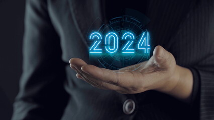 Businessman holding to year 2024 to start preparations for Merry Christmas and Happy New Year. business planning ideas