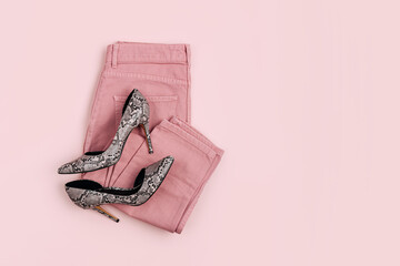 Pale pink jeans and  heeled shoes. Fashion spring, summer or autumn outfit. Women's stylish and elegant clothes with accessory.  Flat lay, top view, overhead.