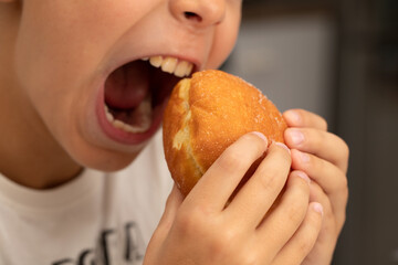 child boy eats food, donut, close-up mouth
