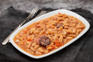 typical portuguese dish dobrada with beans in white dish