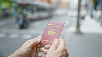 Middle age man with grey hair holding passport of france at street
