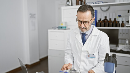 Serious, grey-haired middle age man â€” a dedicated scientist engrossed in reading medical documents in his lab, surrounded by science-tech, chemistry tubes, immersed in complex analysis