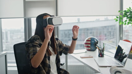 Focused programmer replacing vr objects at office. Headset woman gesturing hands