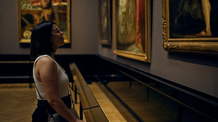 Young beautiful hispanic woman visiting art gallery at Art Museum in Vienna - obrazy, fototapety, plakaty