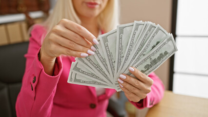 Blonde business boss, happy young woman counting dollars in the office, radiating confidence and investment success