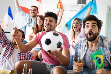 Group of friends having fun at home, watching game and enjoying together.