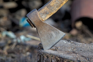 Photo of ax on stumps wood close-up.