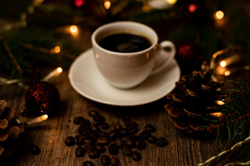 Coffee break on Christmas evening. A cup of espresso coffee on the table