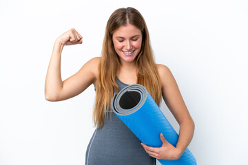 Young sport woman going to yoga classes while holding a mat doing strong gesture
