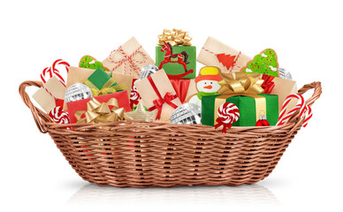 Fototapeta na wymiar Christmas wicker basket full of gifts, sweets and decorations. highlighted on a white background