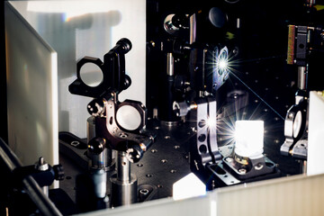 Experiment with laser device in optical laboratory. Experiment in optic lab with laser device....