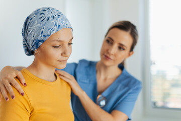Teenage oncology patient talking with doctor. Oncologist treating teen girl with cancer and provide...