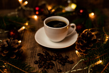 Coffee break on Christmas evening. A cup of espresso coffee on the table