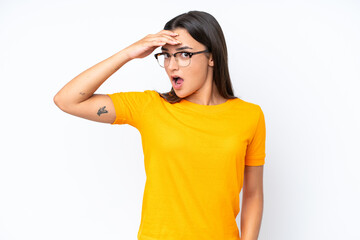 Young caucasian woman isolated on white background doing surprise gesture while looking to the side