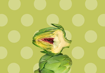 Creative layout made of artichoke on the green background with dots. Flat lay. Food concept. Macro...