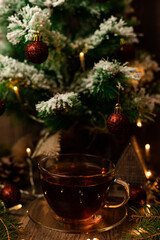 Cup of tea with croissant near Christmas tree.New Year's Eve at home with family