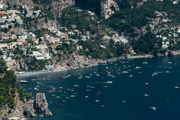 Amalfi Sea Coast with Umbrellas, people swim, and Yachts. Clean and blue sea where to swim. Photo...