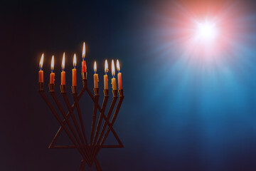 Hanukkiah menorah with burning candles is traditional religious symbol of Jewish holiday Hanukkah