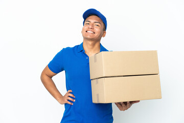 Delivery Ecuadorian man isolated on white background posing with arms at hip and smiling