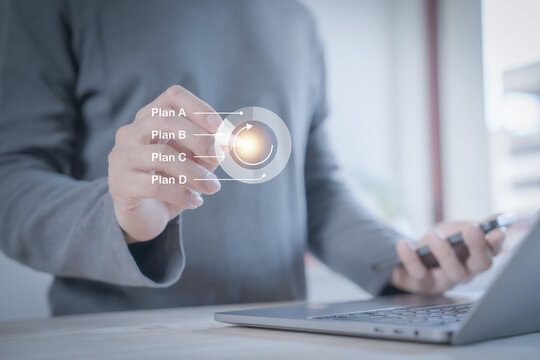 person planning the business plans and analyse  profitability of working companies with digital augmented reality graphics for project manager working on laptop and updating business plan