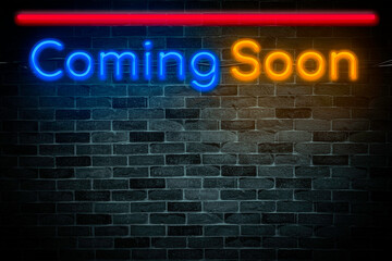 Coming soon neon banner on brick wall background with copy space.