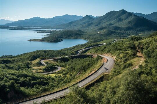 Enchanting winding mountain road gracefully vanishing into the captivating distant scenic beauty