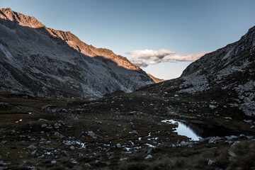 landscape in the morning in the alps with a small lake