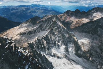 panoramic view of rocky mountains in the alps on a cloudy day with highlights