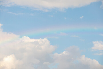 Beautiful rainbow with clouds and blue sky