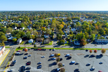 Half empty large asphalt parking lot for cars near shopping center