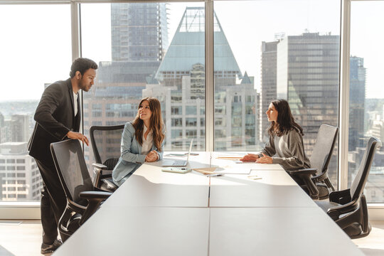 Smiling business people working in modern office, talking, cooperation, sharing ideas