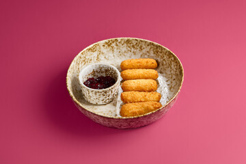 Cheese Sticks with Cherry Jam on Vibrant Background