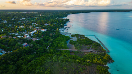 Aerial of seven colours lake lagoon in Bacalar Mexico drone fly above beach resort town in Quintana...