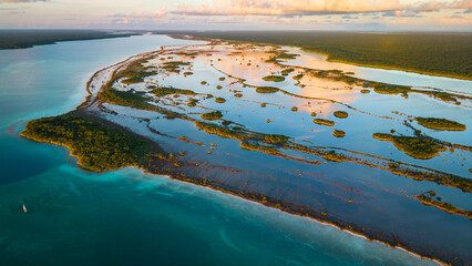 aerial of Bacalar laguna lake 7 seven colours at sunset Mexican resort beach town tourist travel...