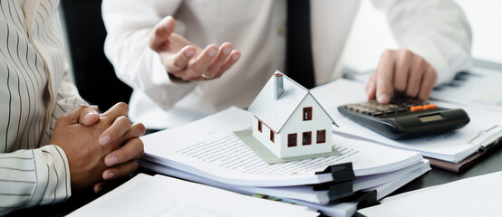 Real estate agent broker and customer with loan or insurance contract documents..