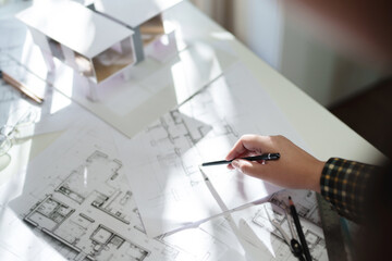 Architects interior designer hands working with Blue prints and documents for a home...