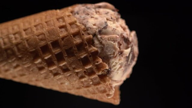 Soft ice cream in a waffle cup on a black background