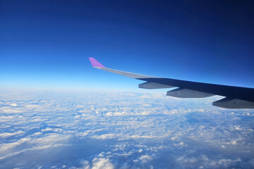 Naklejka na ściany i meble Close up Airplane Wing with Beautiful Blue Sky Background.