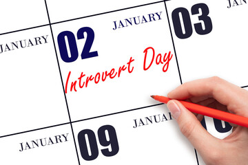 January 2. Hand writing text Introvert Day on calendar date. Save the date.