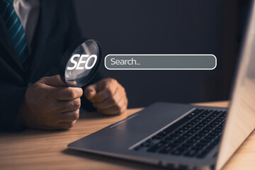 Businessman sit in suit holding magnifying glass.Searching Browsing Internet Data Information with blank search bar. Search Engine Optimization SEO Networking Concept.