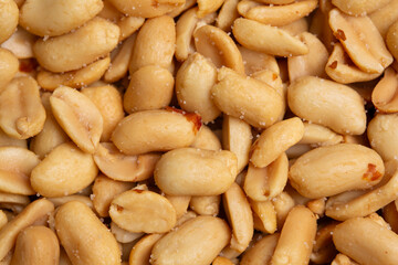 Peanuts look delicious. Close-up of peeled, roasted, salted peanuts background.