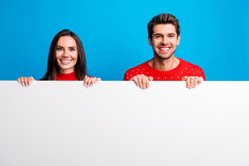Photo portrait of attractive young couple hide behind white wall wear x-mas ornament red sweaters...