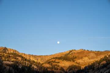 Fototapeta na wymiar Moon rising over the mountains near Dubois, Wyoming at dusk