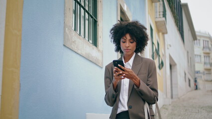 Woman blogger walking city making photo on phone. Tourist taking picture town.