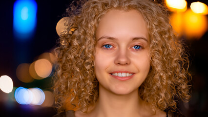 Portrait of a beautiful young woman with curly hair and blue eyes