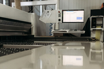 A modern machine for cutting slabs of furniture fittings.