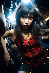 Fototapeta premium A nice looking asian college girl dancing in a club