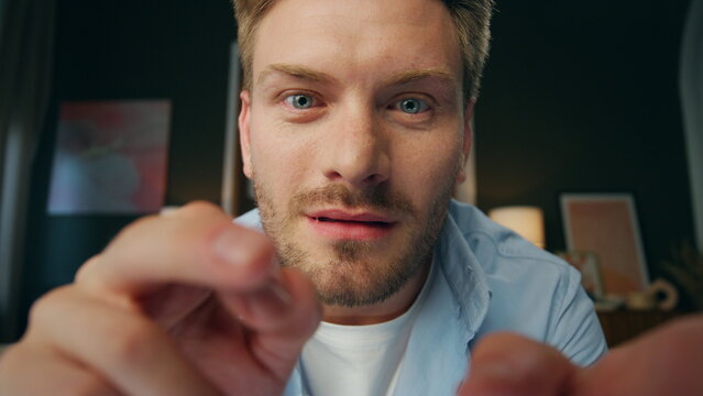 Pov surprised man typing fingers screen at house. Wondering guy face closeup