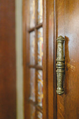 A Majestic Door Handle: Intricate Design and Rich History Reflected in Wood and Metal Details